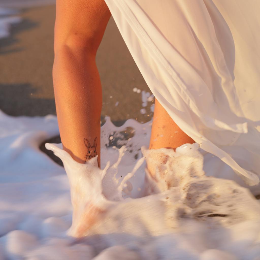 Woman enjoying smooth legs after leg waxing process.