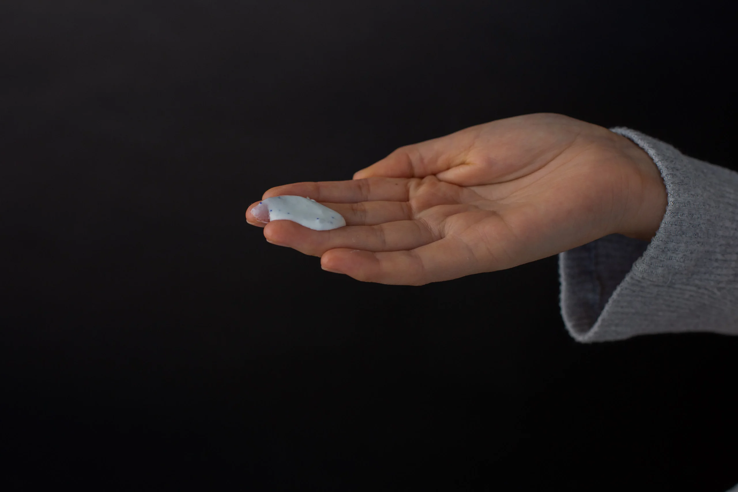 A person applying a gentle, moisturizing lotion to freshly waxed skin. Focus on skin texture and soothing application. Keywords: post-wax care, moisturizing lotion, smooth skin, hair removal aftercare, skin hydration