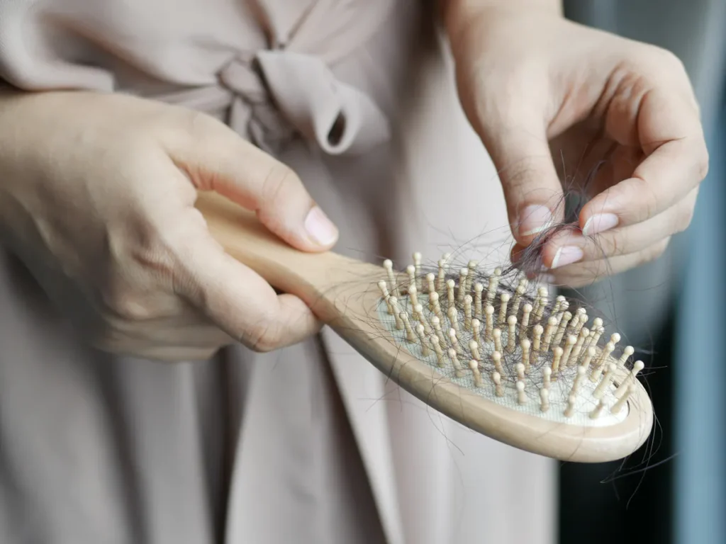 A woman with smooth, hair-free legs smiling confidently, showcasing the results of effective hair removal.