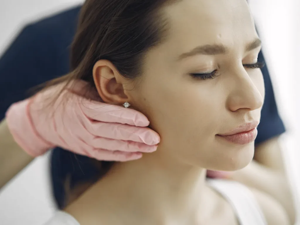 A woman with glowing, smooth skin smiles confidently after a waxing session. The image conveys the benefits of professional hair removal for achieving radiant skin.