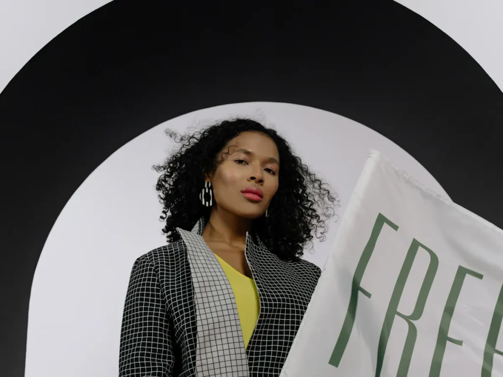 A person with smooth, hair-free skin smiling confidently. The background subtly shows a high-tech laser waxing device. Alt text: Confident individual enjoying the benefits of advanced laser waxing for permanent hair reduction.