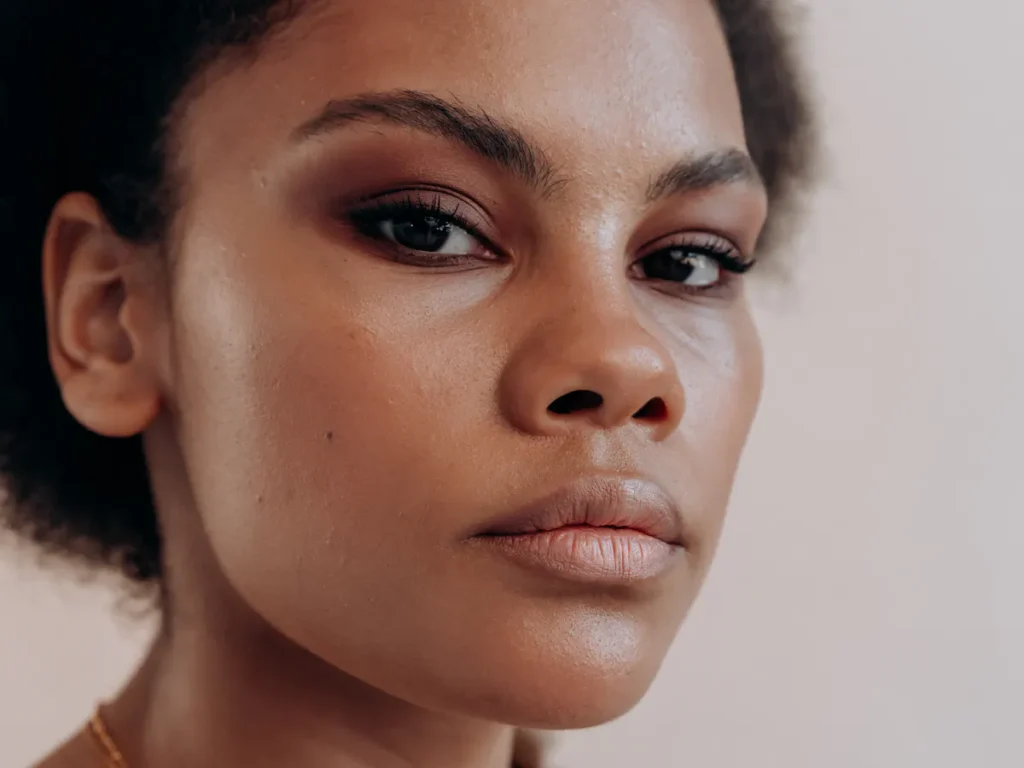 A woman with smooth, flawless skin after a waxing treatment in an Amsterdam salon. The image should convey cleanliness and beauty.