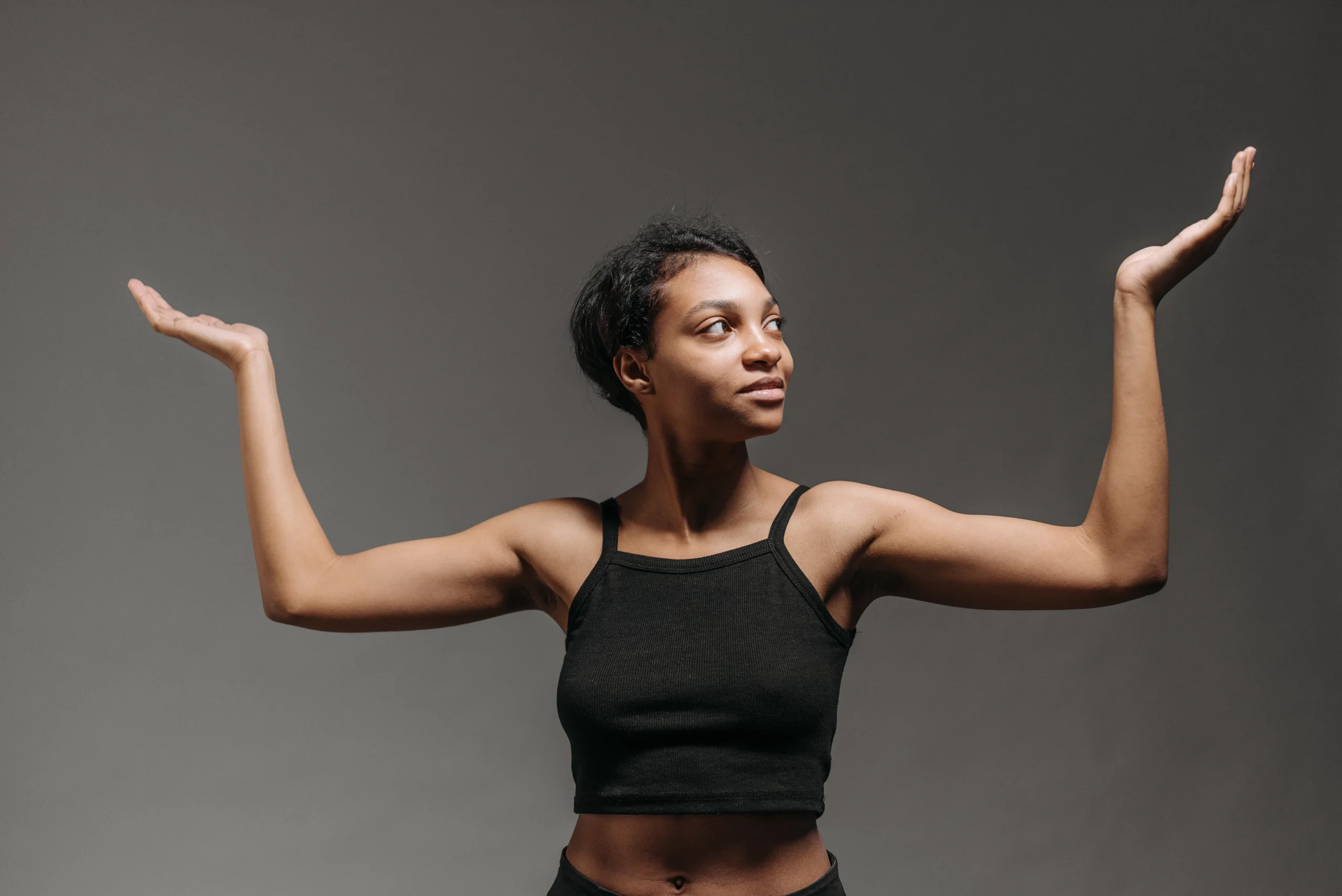 A woman confidently wearing a sleeveless dress, showcasing her smooth arms after laser waxing. alt_text: Laser waxing provides a confidence boost with smooth, hair-free skin. img_url: [insert high-quality image URL here]