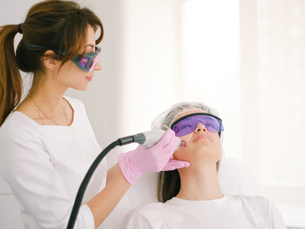 An aesthetic clinic technician performing laser waxing