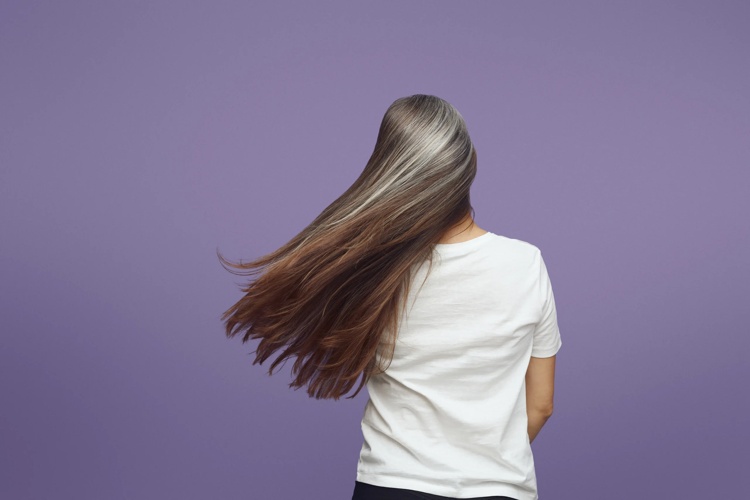 Back view of woman with long gray and brown ombre hair