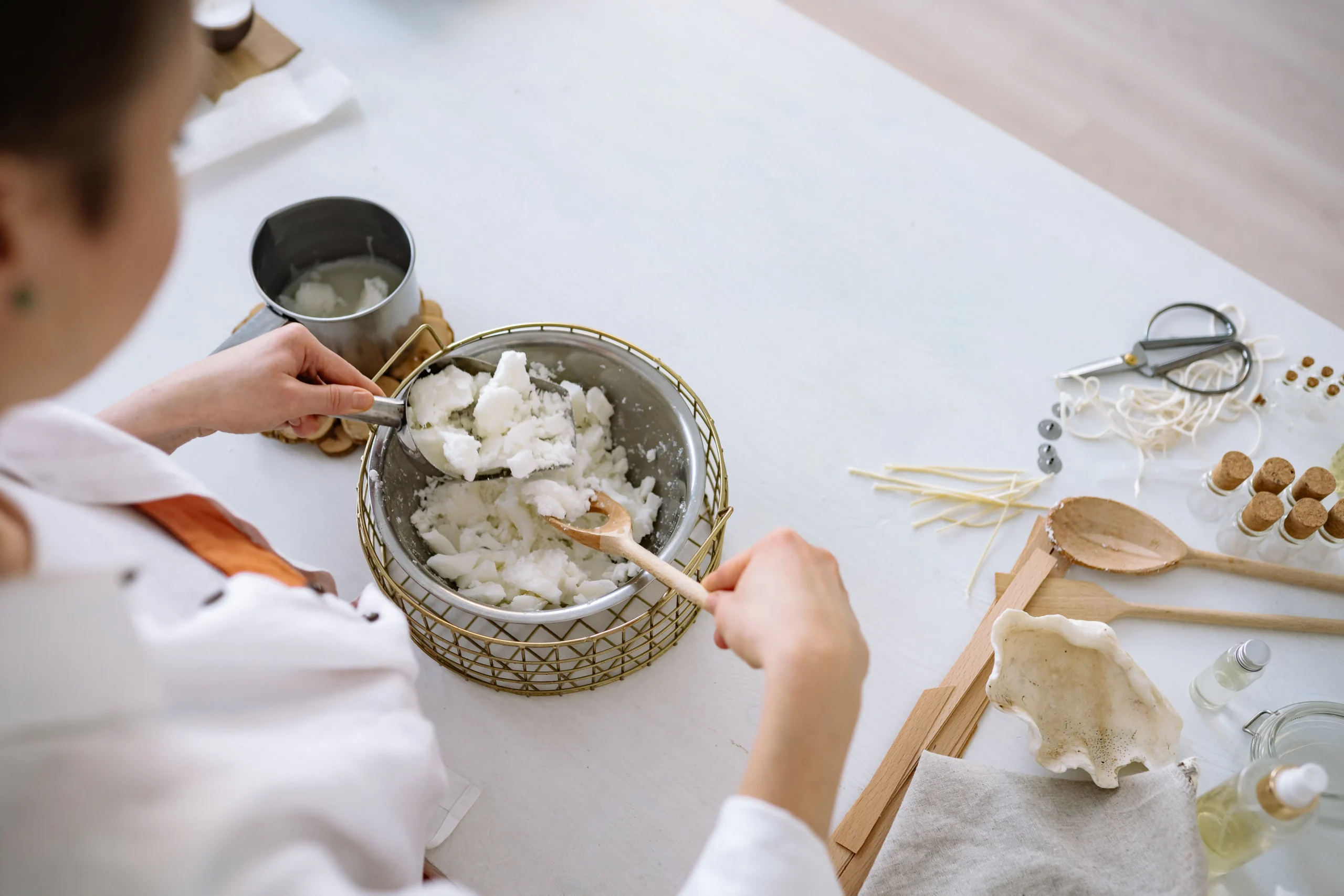Image of person mixing ingredients in a bowl, not directly related to leg waxing, but could be for a homemade wax or aftercare product.