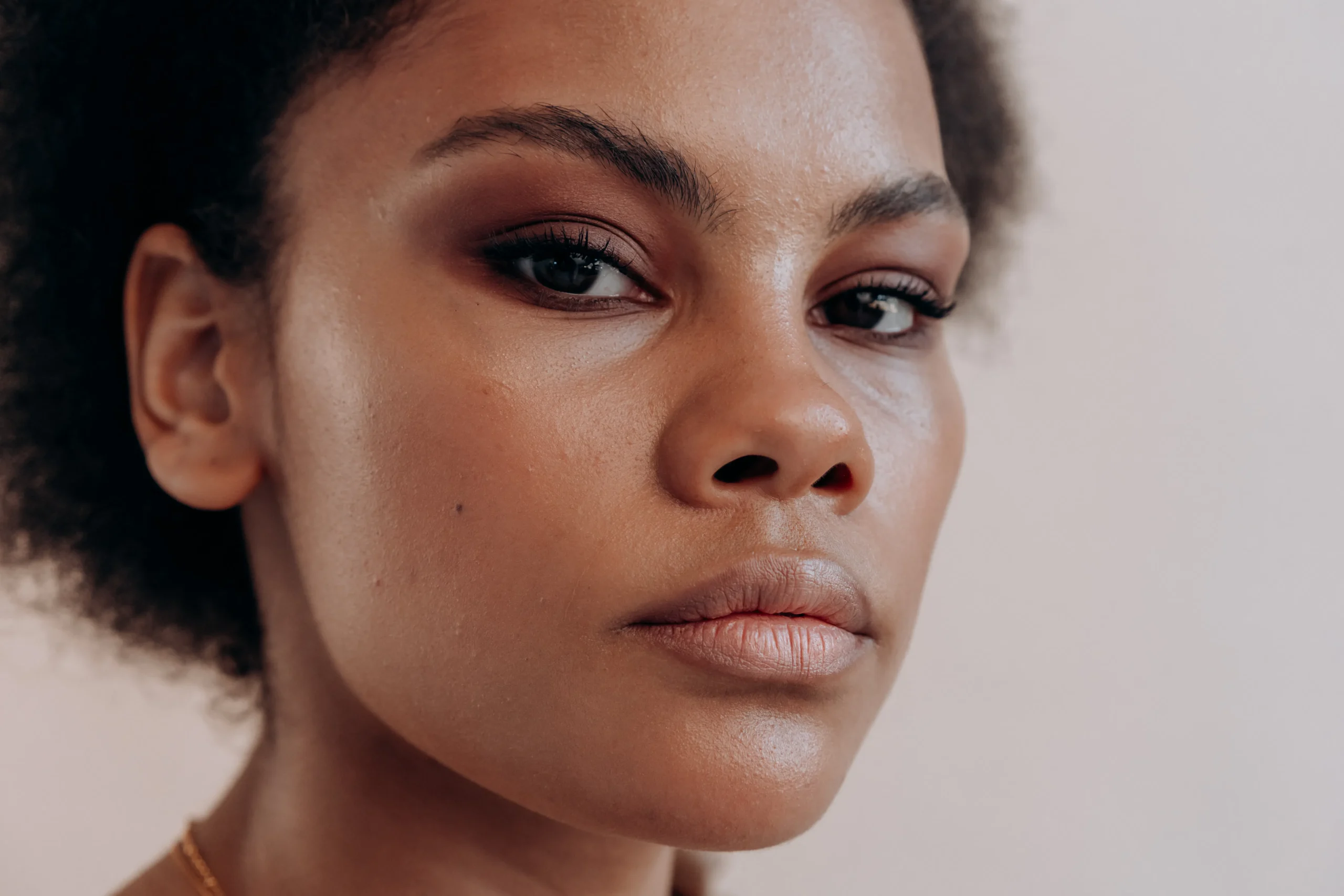 Close-up portrait of a woman with neutral makeup.
