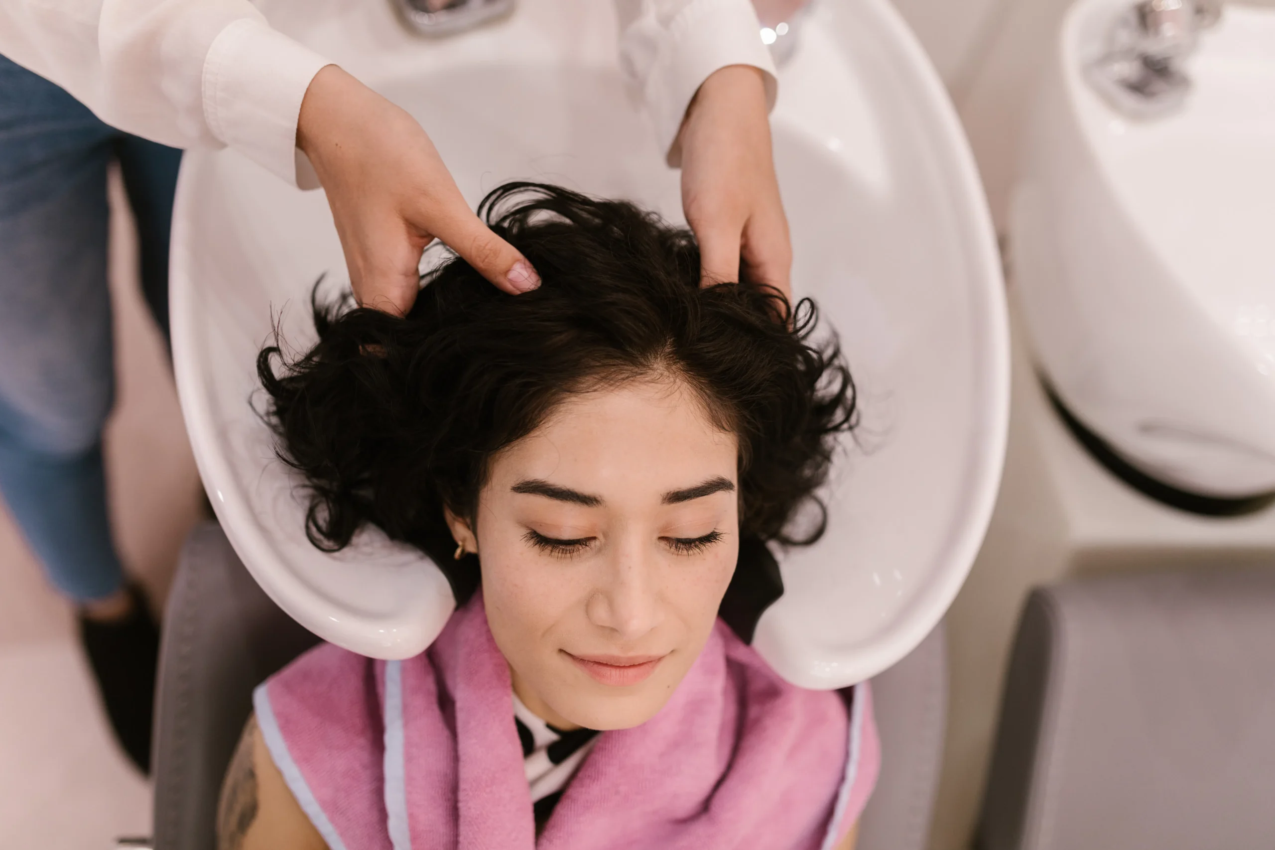 Woman relaxing with a hair wash at an Amsterdam beauty salon.
