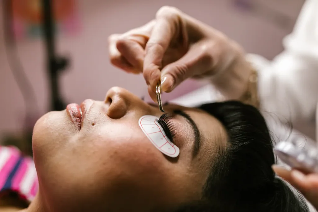 Woman receiving eyelash extensions at an Amsterdam beauty salon.