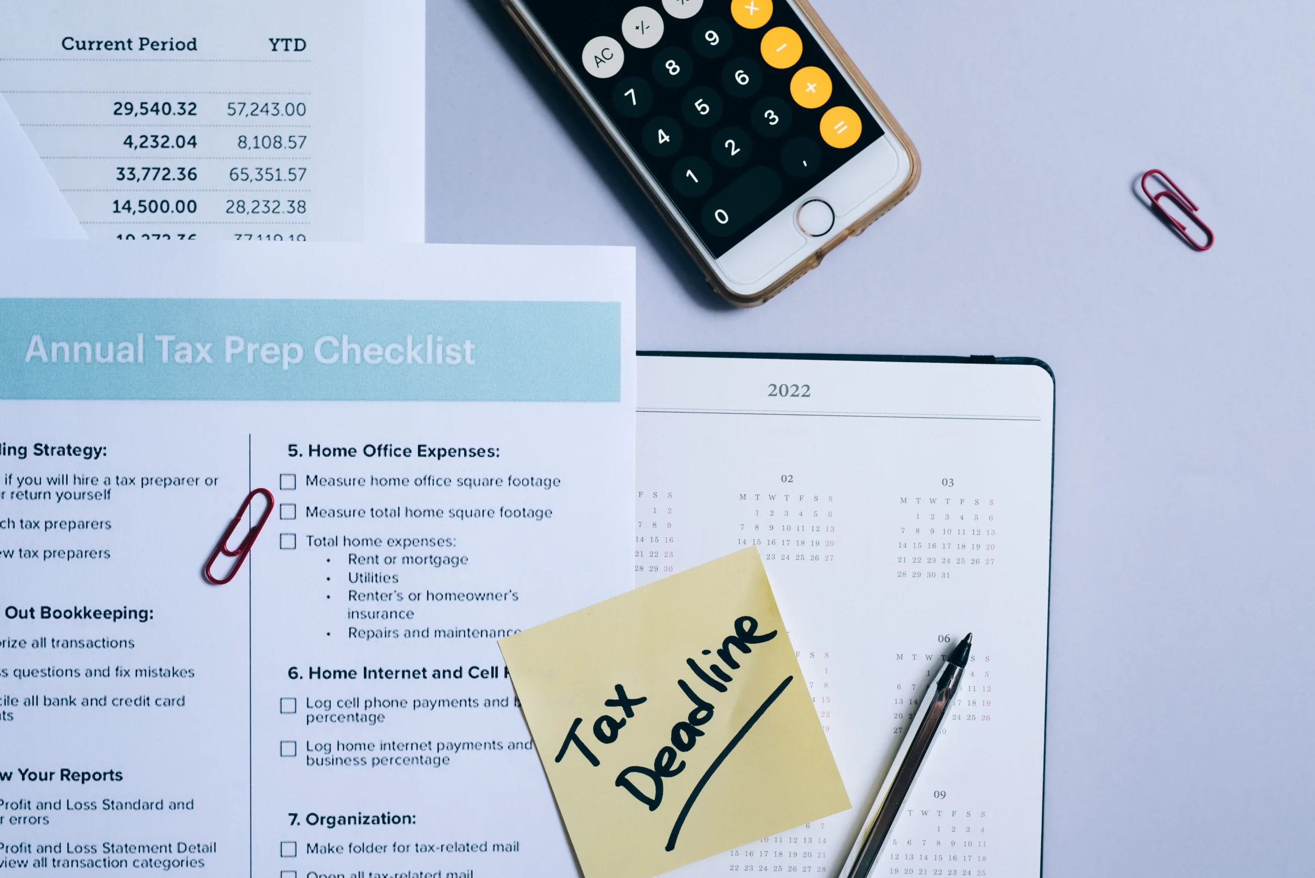 Tax deadline reminder, calculator, and tax prep checklist on a desk.