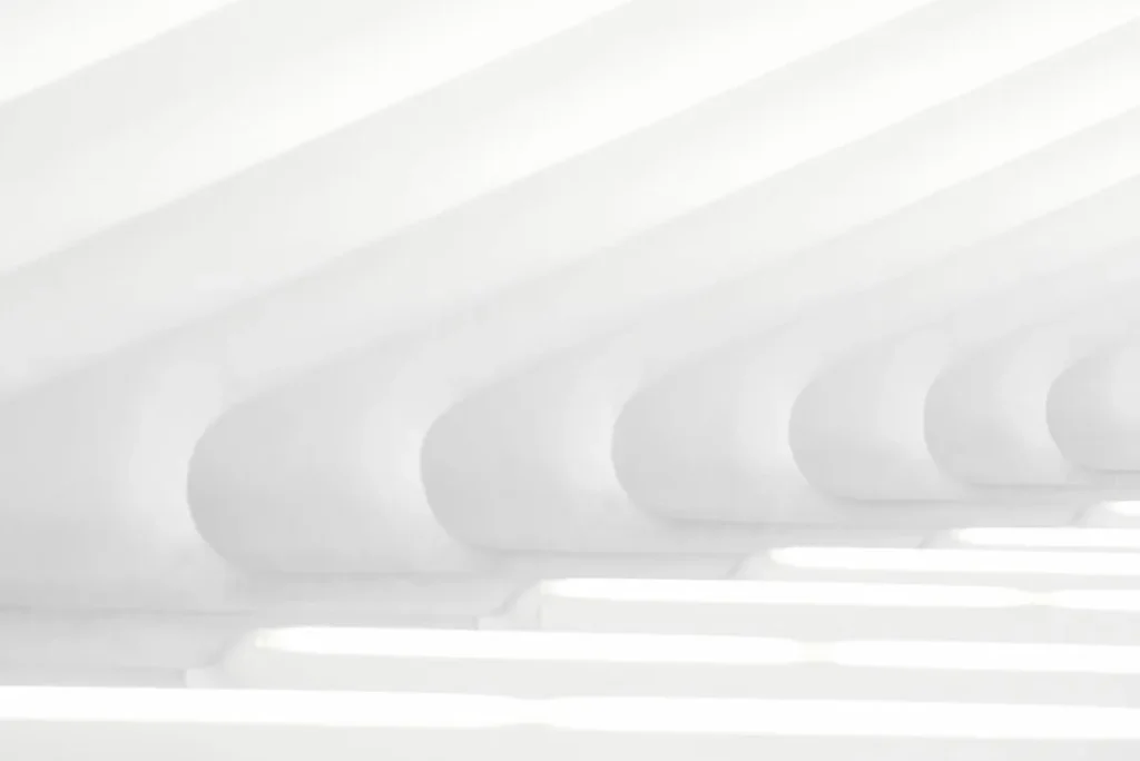Abstract architecture with repeating white arches and soft light