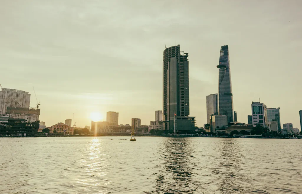 Distant cityscape of Ho Chi Minh City across the Saigon River at sunset
