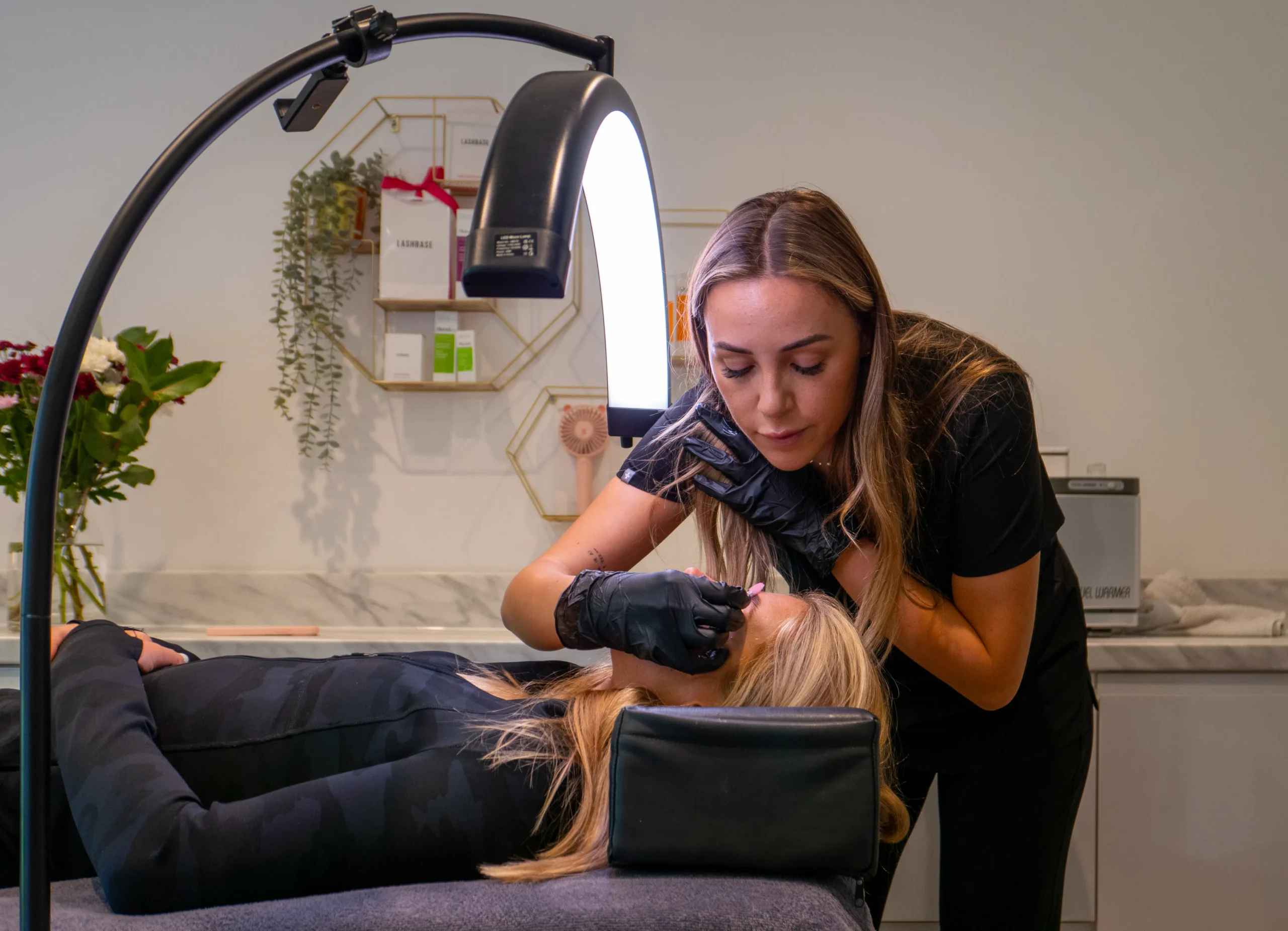 Waxing specialist performing a bikini wax in an Amsterdam salon, aiming for smooth skin.
