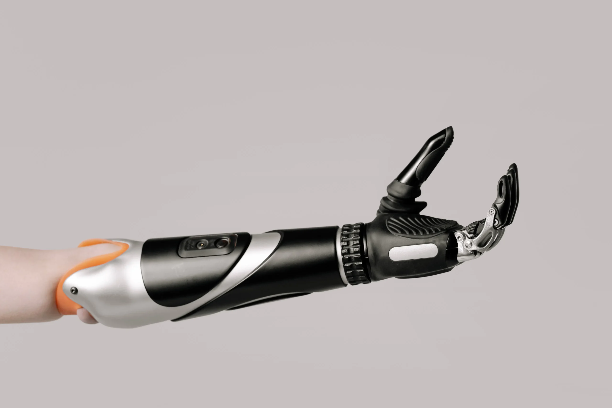 A modern prosthetic arm with silver, black, and orange components.