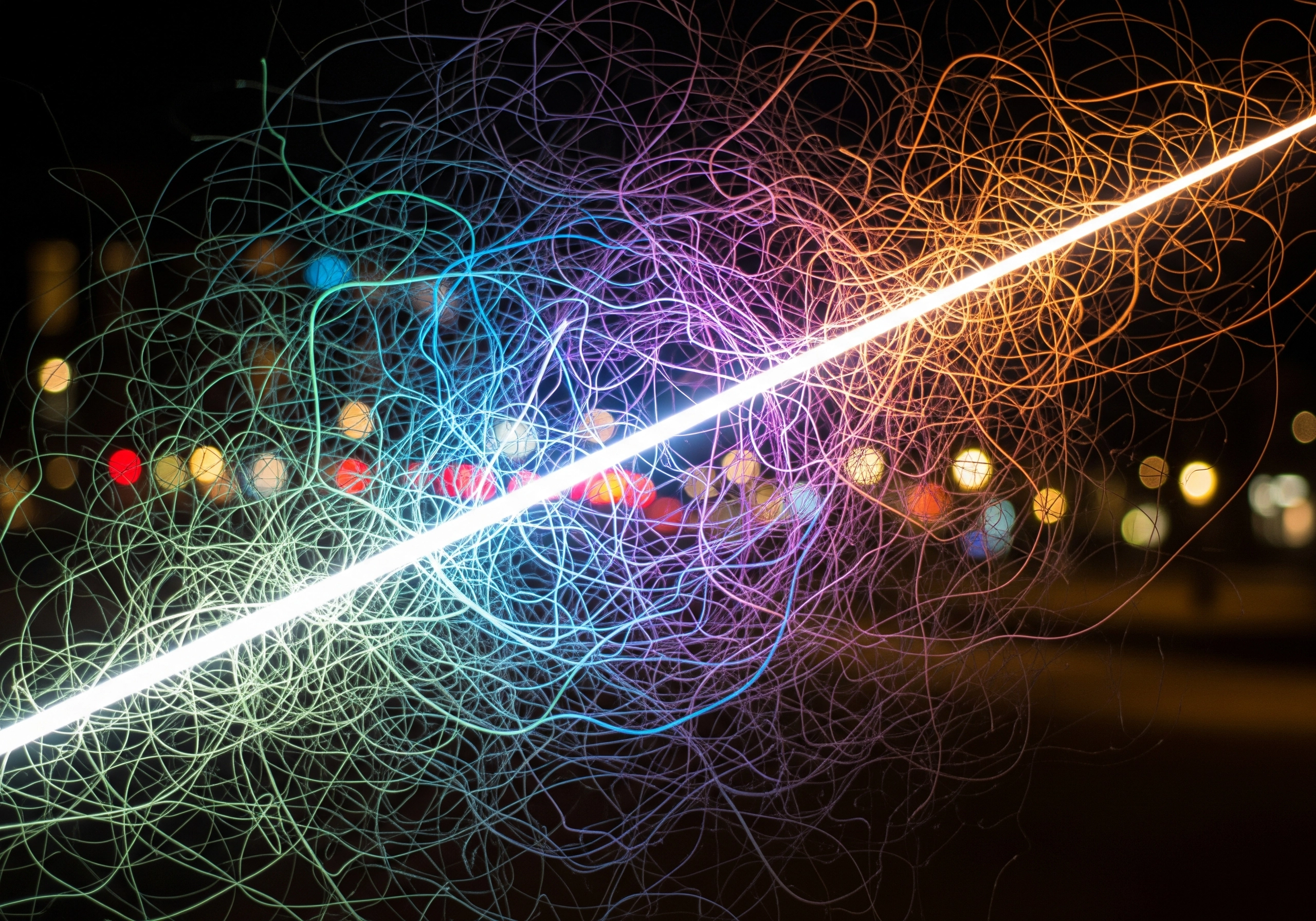 Abstract light streaks on black, symbolizing laser energy used in a carbon peel.