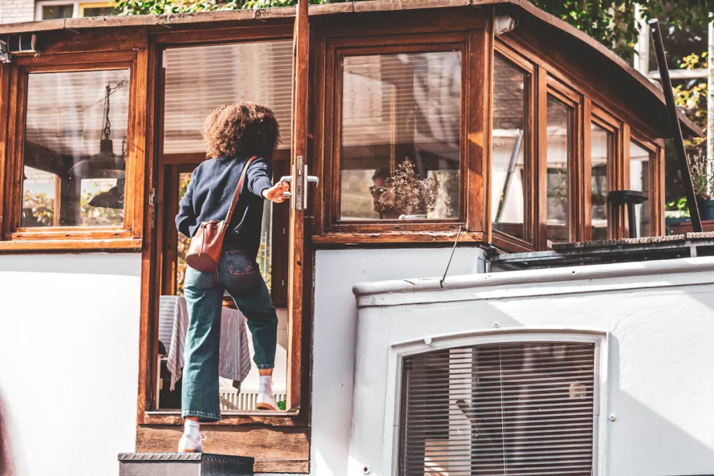 Woman entering an Amsterdam canal house; a common sight for Amsterdammers seeking skin care.