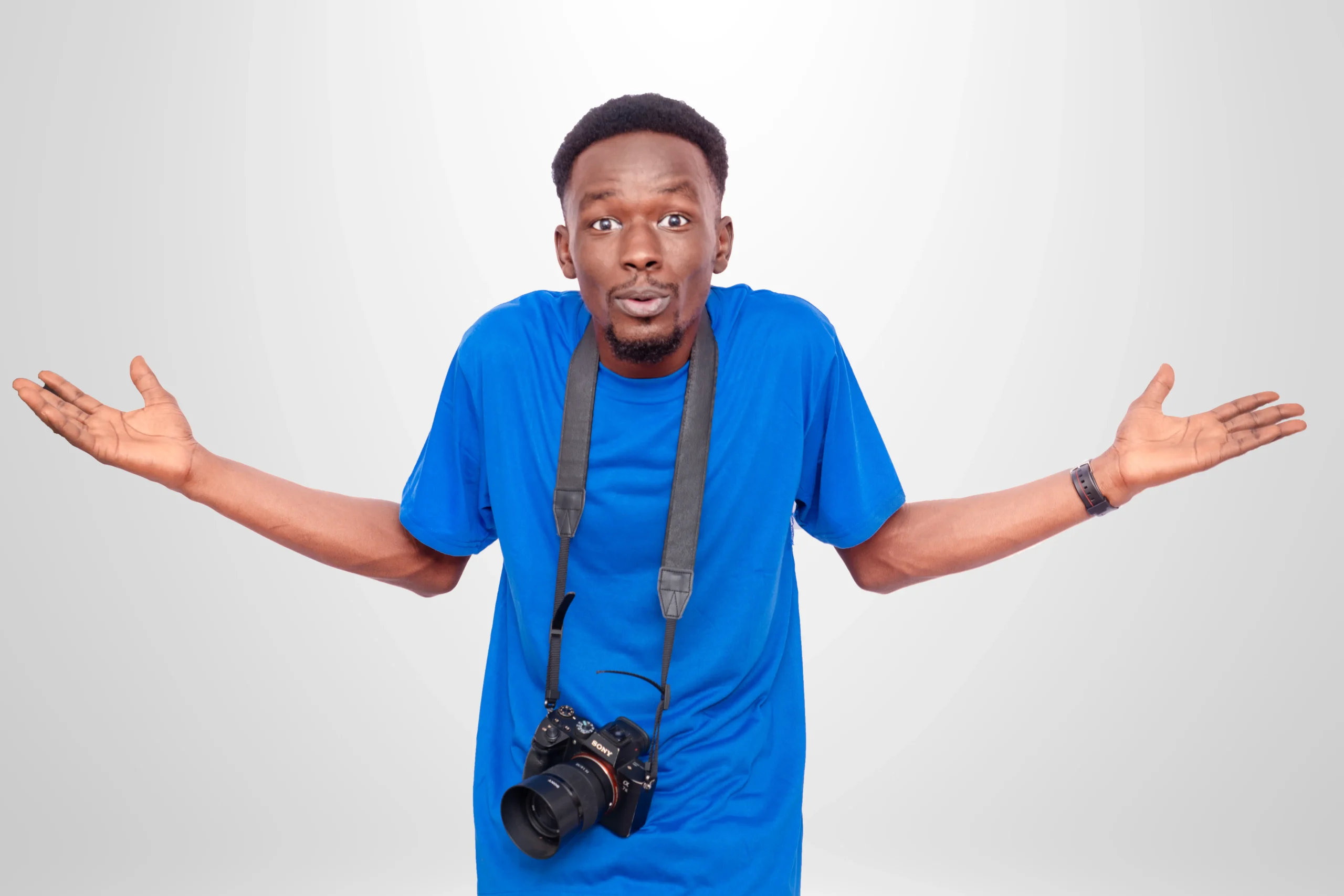 Man in blue shirt with camera shrugs, questioning skin treatment myths 2026.