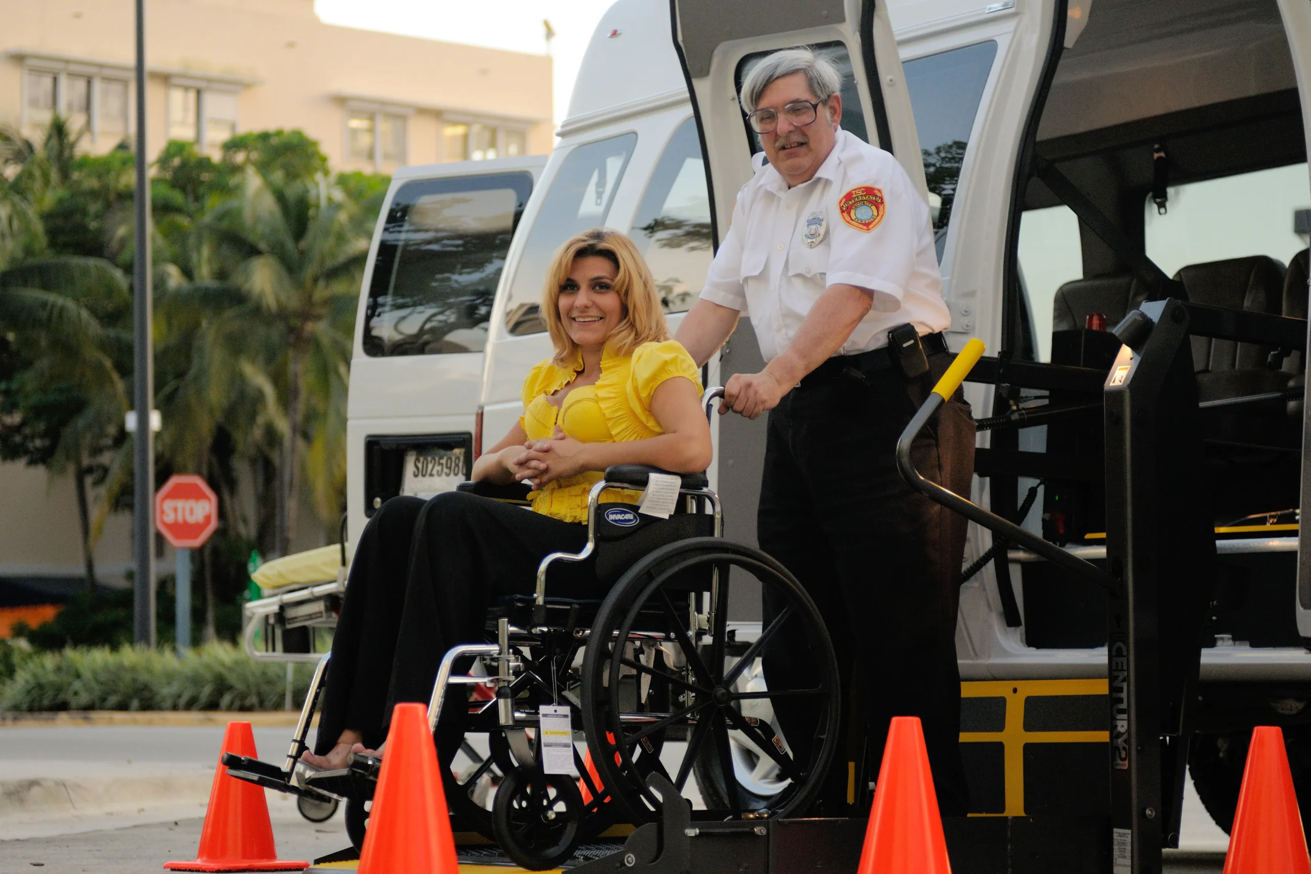 Woman in wheelchair is assisted with accessible van transport.