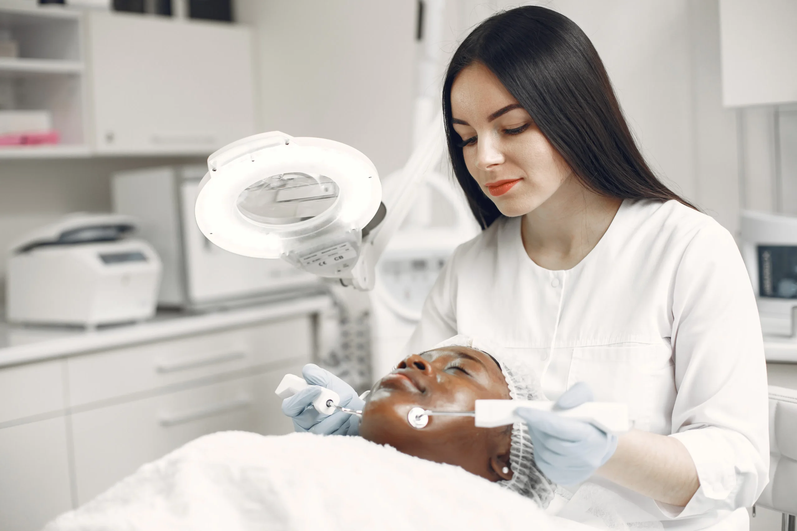 Woman receiving a carbon laser peel facial treatment for skin rejuvenation in Amsterdam.