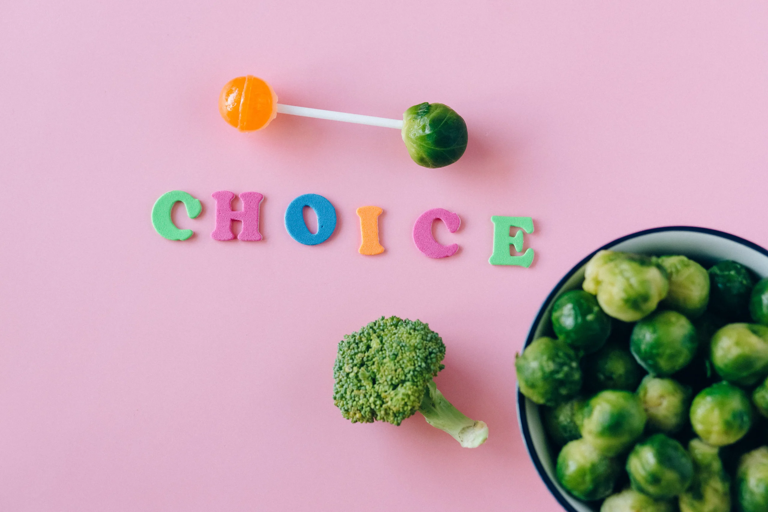 The word CHOICE spelled out with broccoli, sprouts, and a lollipop.