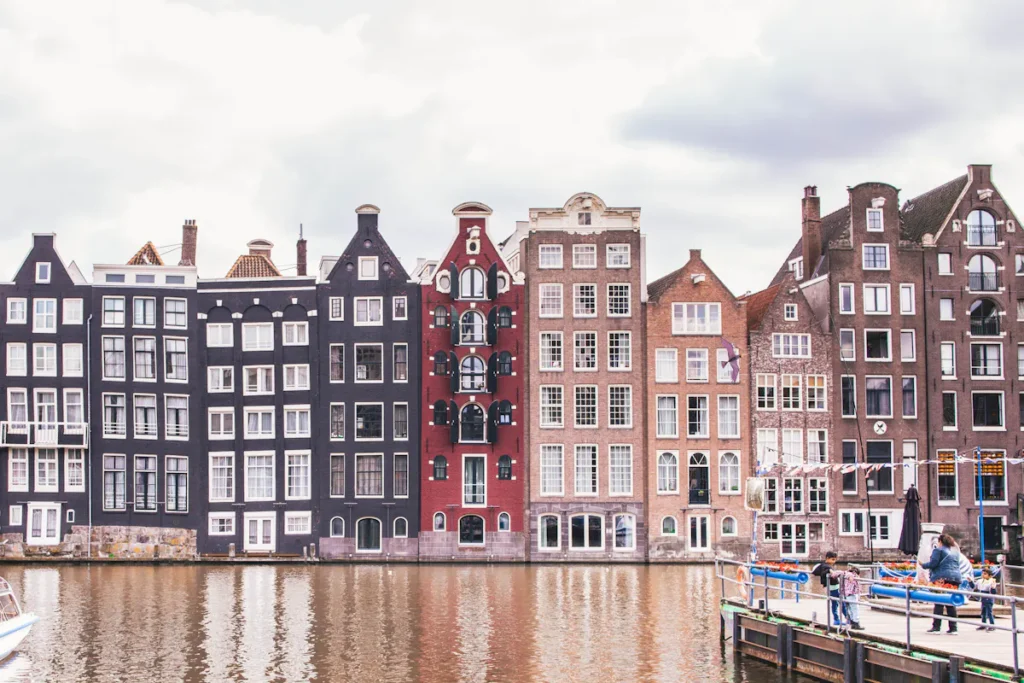 Amsterdam canal houses reflecting in the water, typical of Amsterdam.
