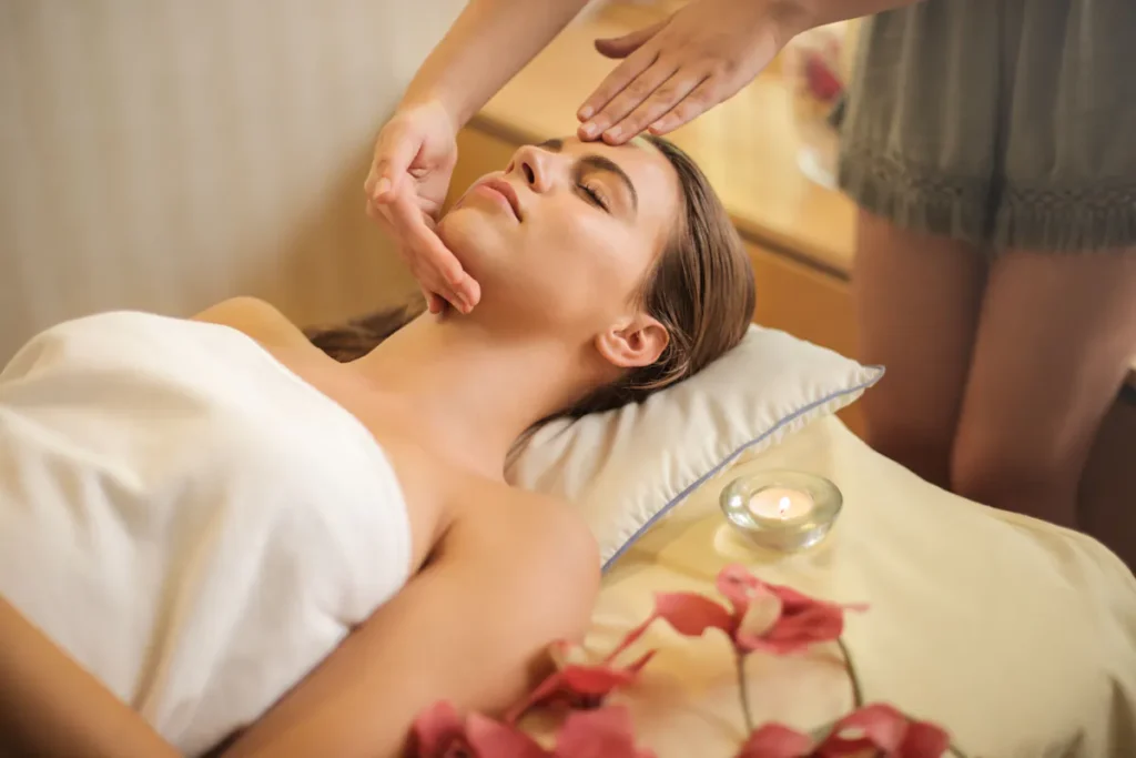 Woman with closed eyes enjoying a relaxing facial massage at a beauty salon, suggesting a top skincare treatment in Amsterdam.