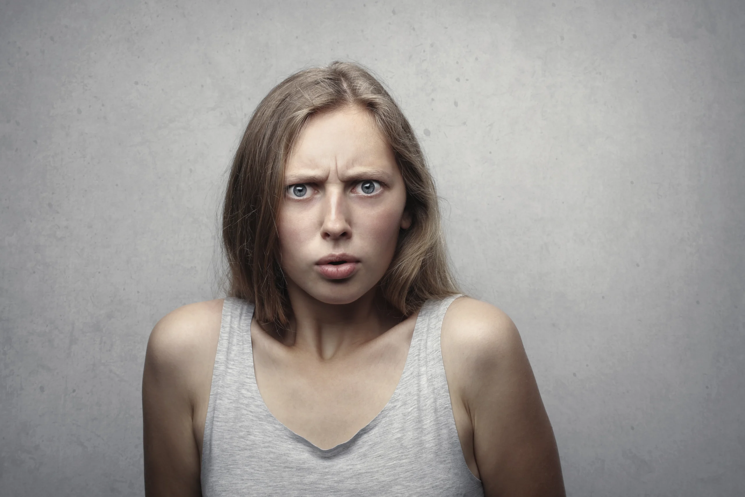 Confused woman with furrowed brow, questioning the carbon peel misconceptions in Amsterdam.