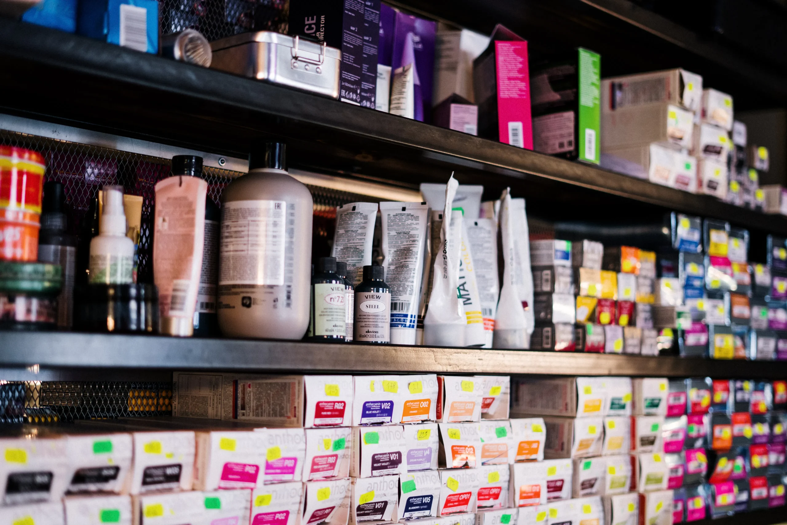 Fully stocked shelves displaying various hair dyes and professional beauty products, indicating a well-equipped beauty salon in Amsterdam