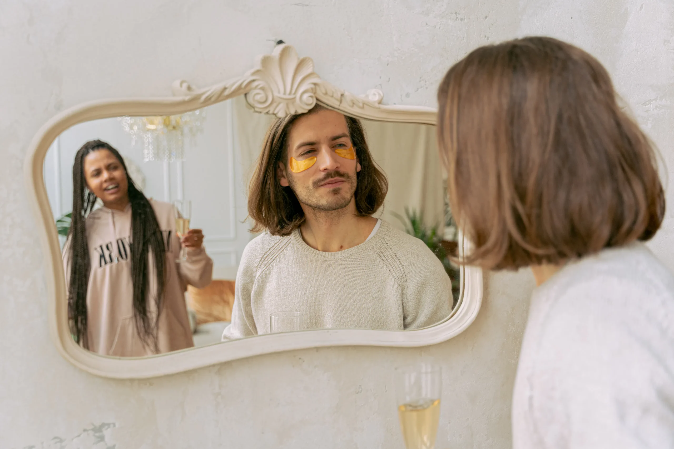 Man with eye mask reflected in mirror at Amsterdam beauty salon; woman behind.
