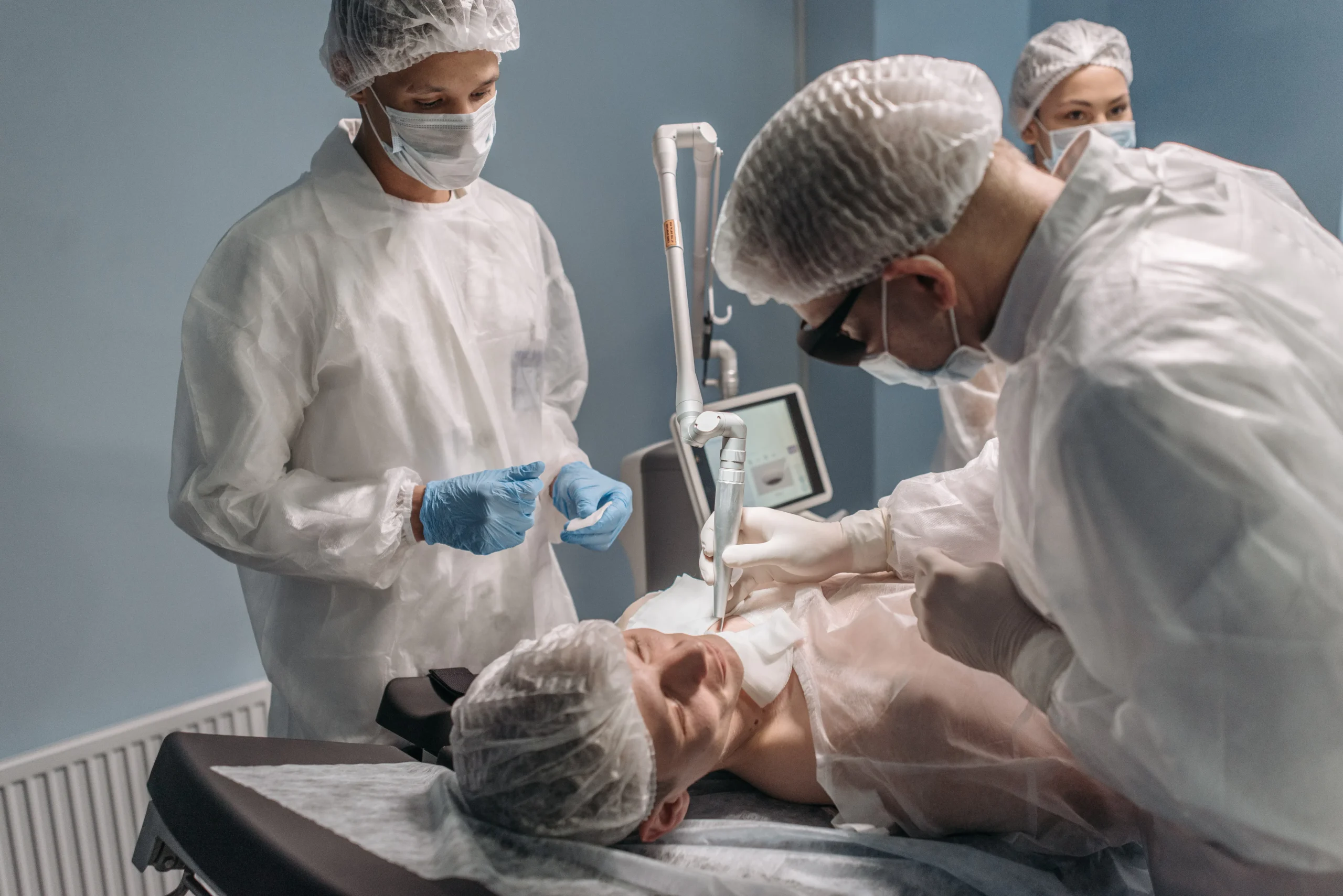 A technician performs a carbon peel laser facial in a salon.