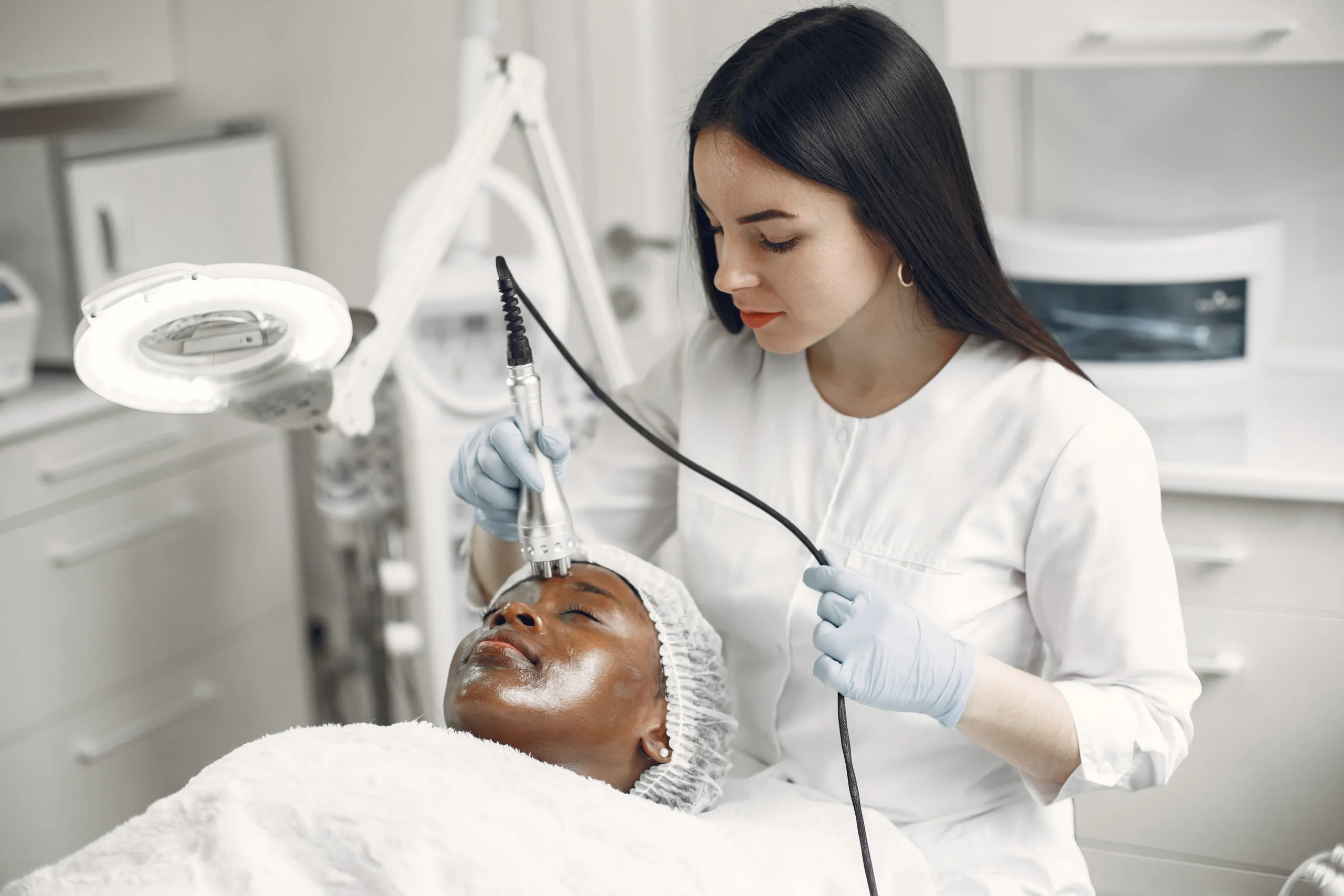 Beauty salon skin treatments showing a carbon laser peel being performed on a client for clear skin.